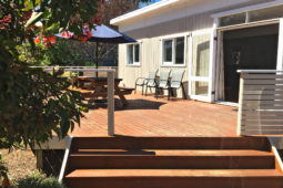 Steps leading to the wraparound wooden deck at Carrington Cottage holiday accommodation on Bruny Island.