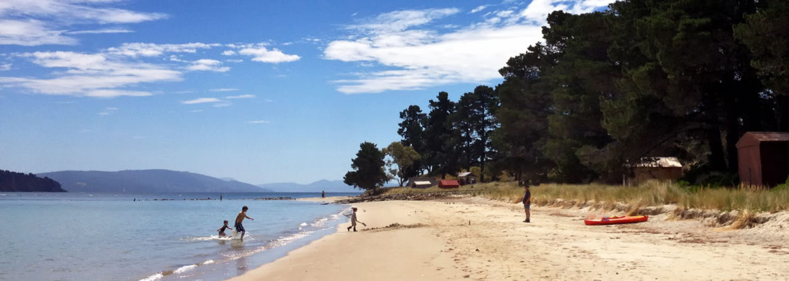 Looking along the beach towards the jetty at Dennes Point, Bruny Island.